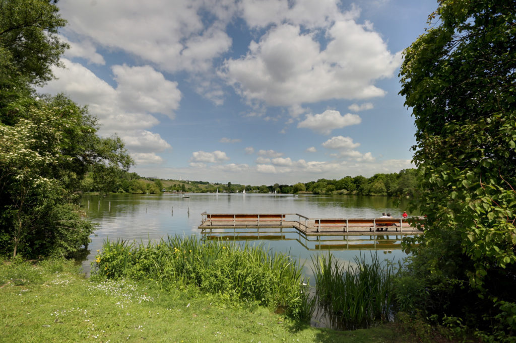 A jetty on the Max-Eyth-See, with sailing dinghies and the Neckar valley beyond